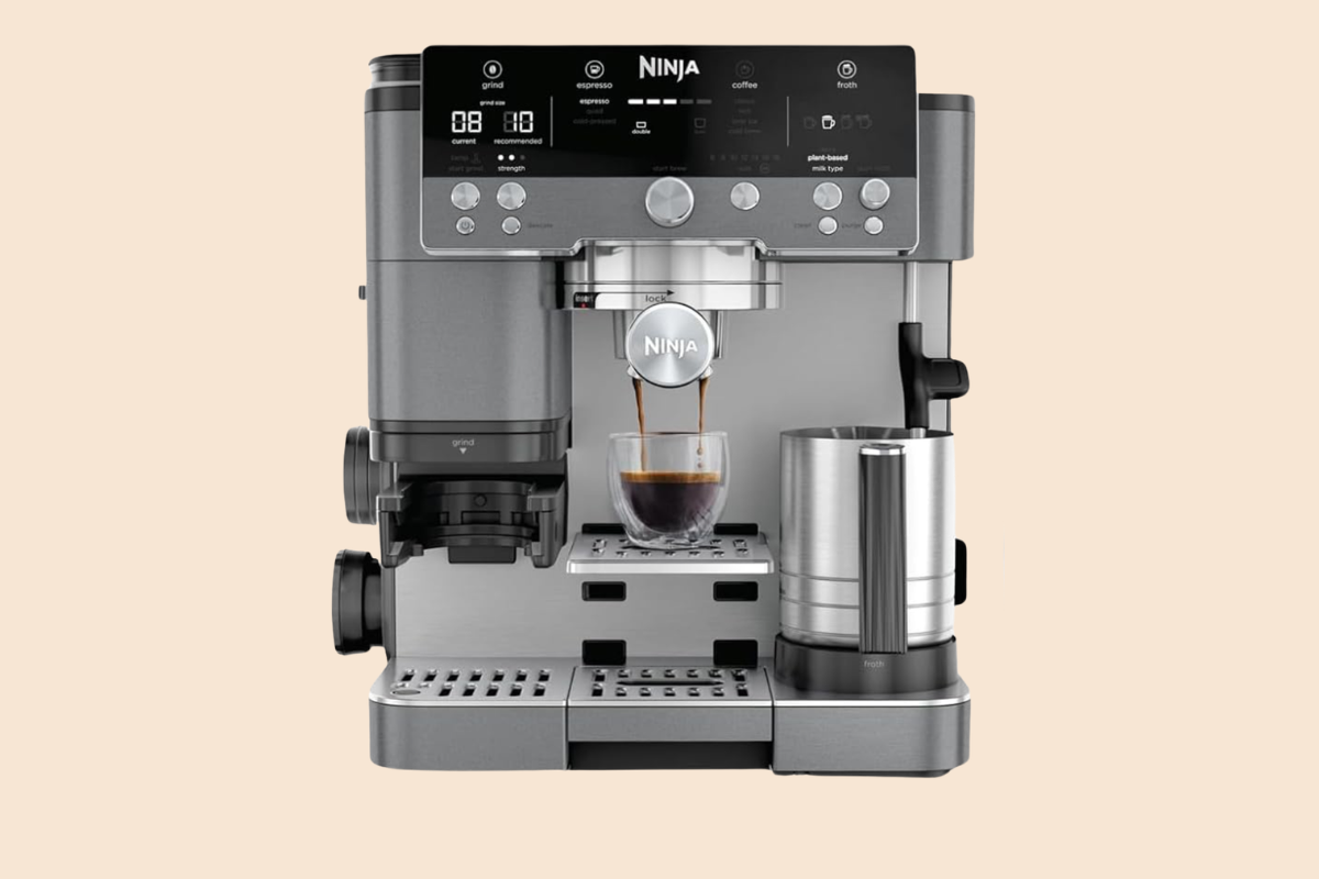 A Ninja Luxe Cafe espresso machine brews a rich shot of espresso into a glass cup, with a milk frother and digital control panel—showcasing the precision of semi automatic espresso machines.